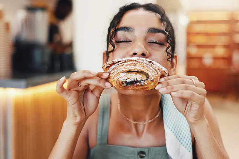 A-woman-eating-a-croissant