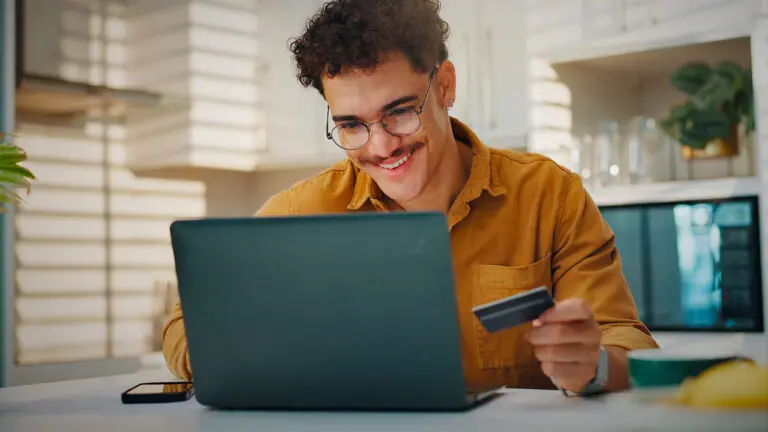 someone shopping with a credit card in hand